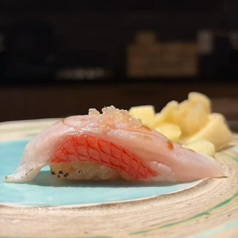 Delicate Kinmedai nigiri with crispy skin and tobiko at Ki Omakase, a Sushi Restaurant in Little Neck